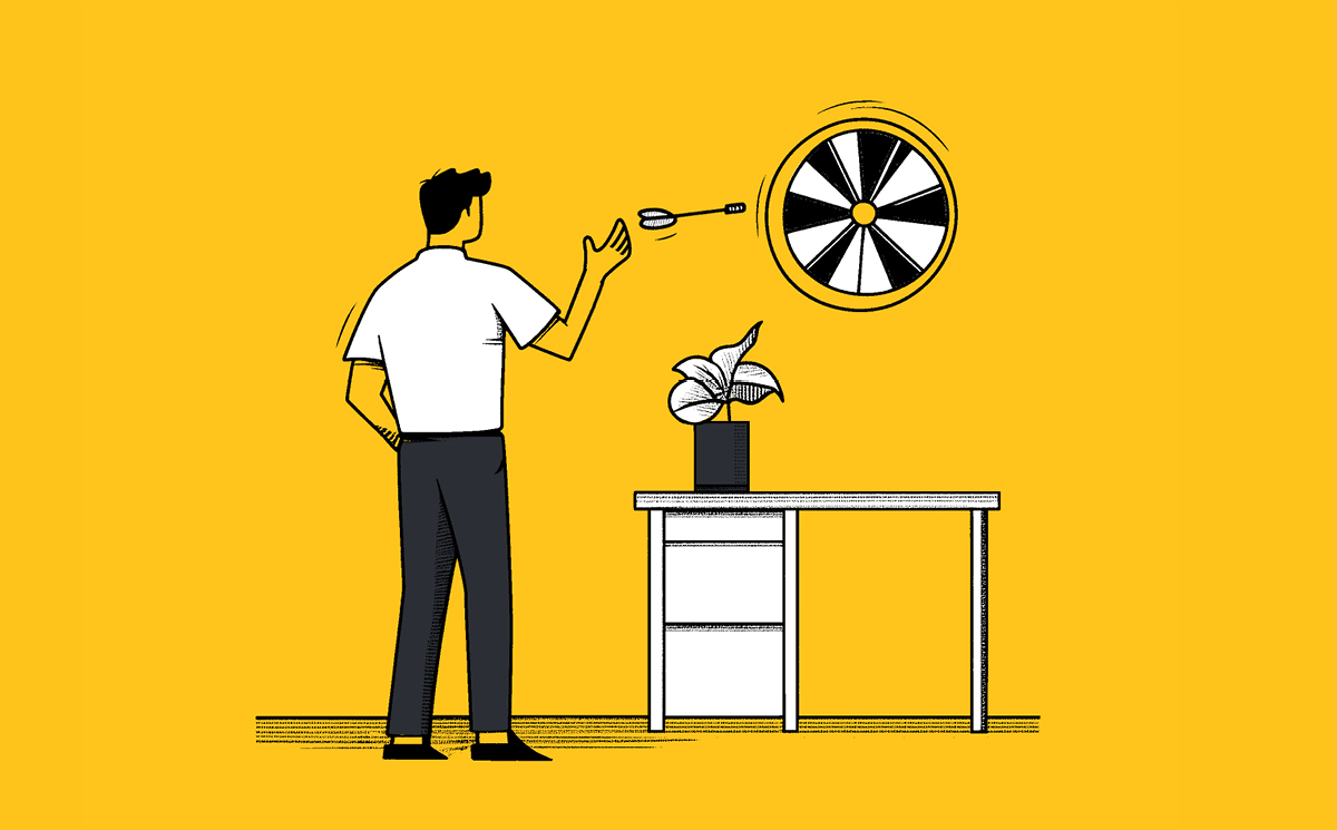 A man in a white shirt, perhaps a marketing leader, throws a dart at a dartboard mounted on a yellow wall. A potted plant sits on the white table beside him, mirroring focus required for those must-read articles planned for Q4/24.