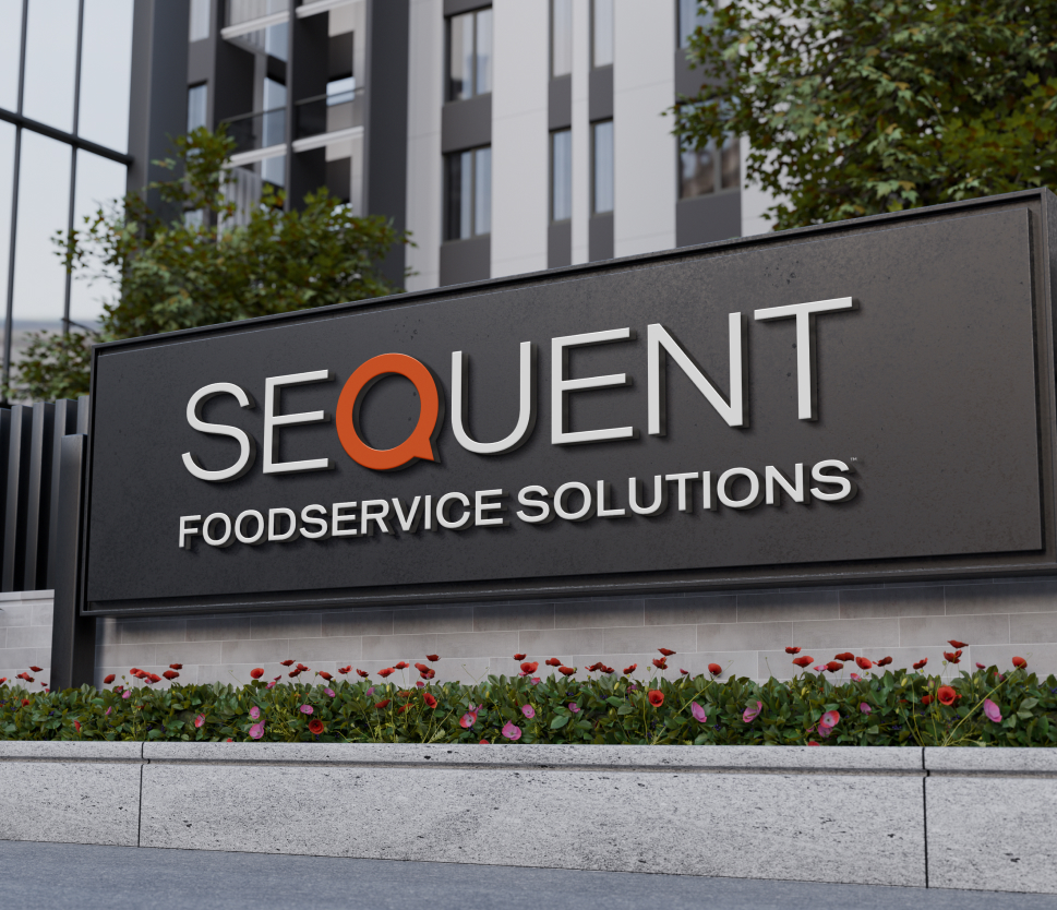A modern outdoor sign reads "SEQUENT FOOD SERVICE SOLUTIONS" in white letters, with the "Q" in orange. The sign is set against a building with plants and flowers in front.