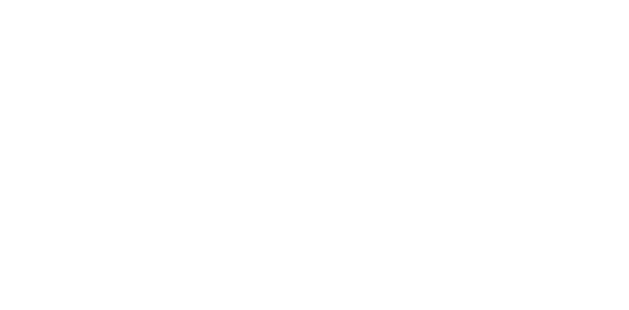 The Susan G. Komen logo in white, featuring stylized text and a ribbon design resembling a running figure, representing the breast cancer awareness organization.