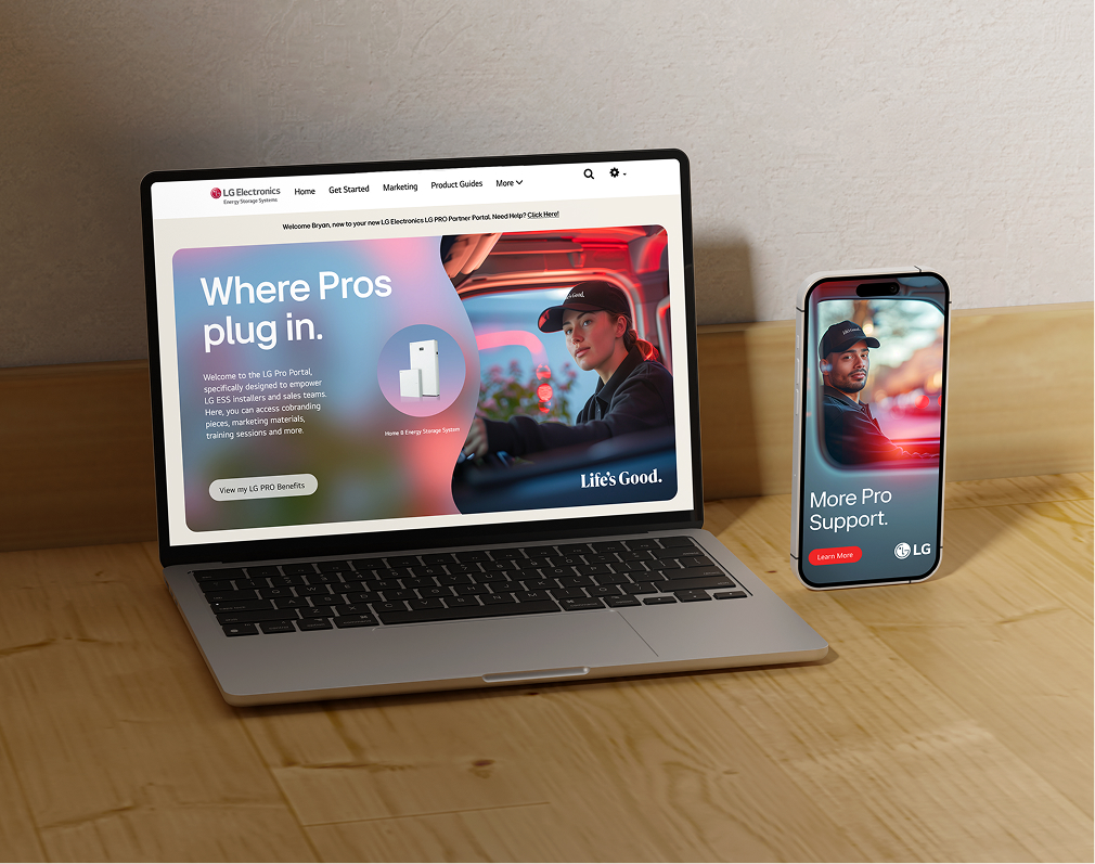 A laptop and a smartphone on a wooden desk display LG Electronics' website, showcasing a woman in a uniform and text about pro support services. The screens feature vibrant colors and the LG logo.