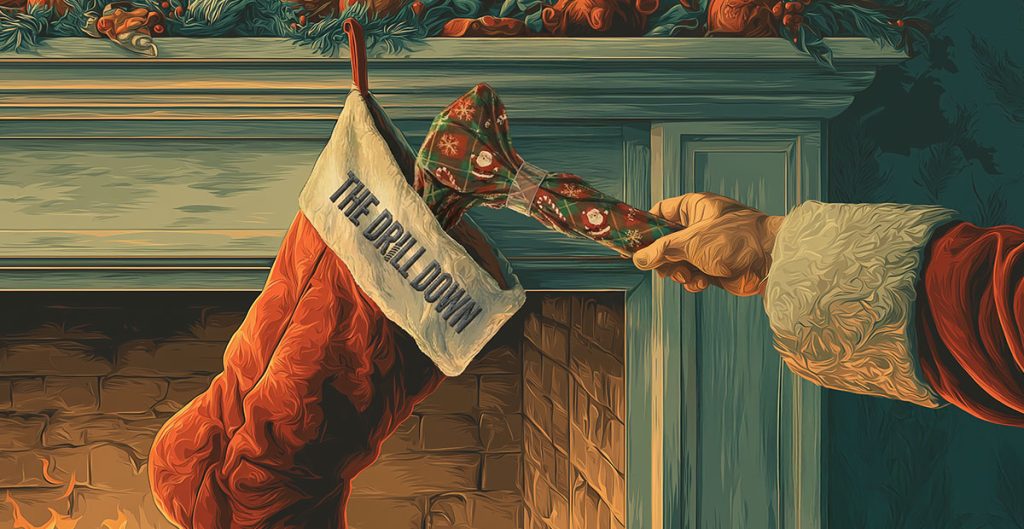 A hand in a Santa sleeve brings good tidings as it places a green, snowflake-patterned bowtie labeled "The Drill Down" into a red Christmas stocking hanging by a fireplace decorated with pine and berries.